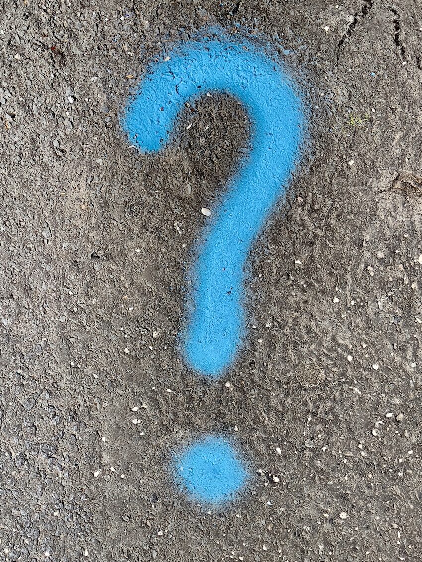 a blue question mark painted on the ground