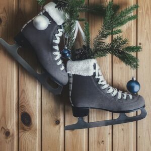 a pair of ice skates sitting on top of a wooden floor
